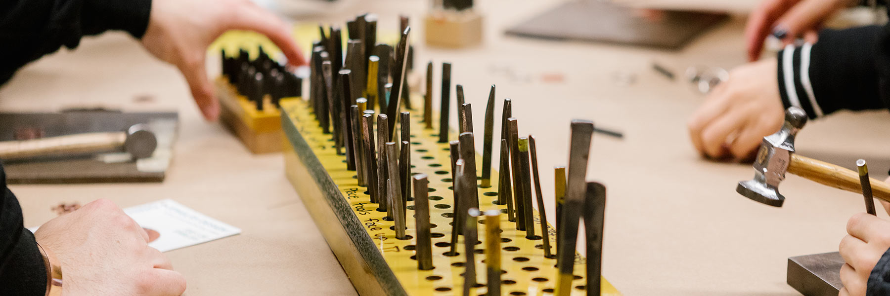 A row of metal tools on a table.
