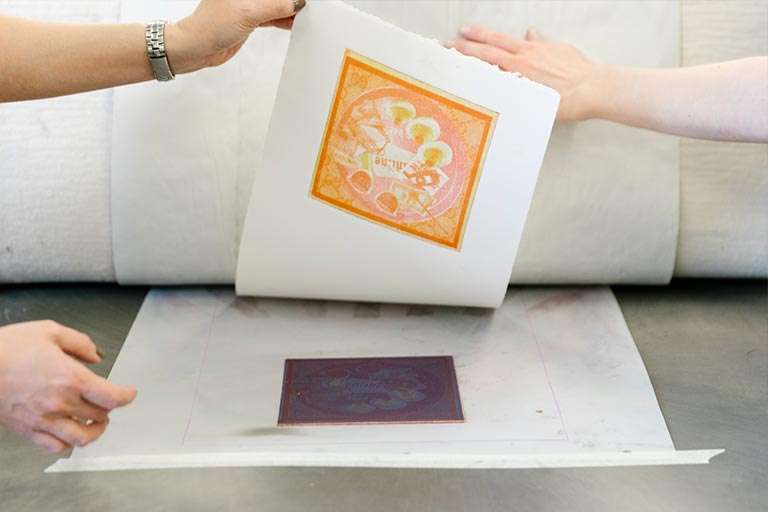 Close up of hands holding a print.