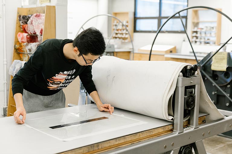 A person works at a printing press.