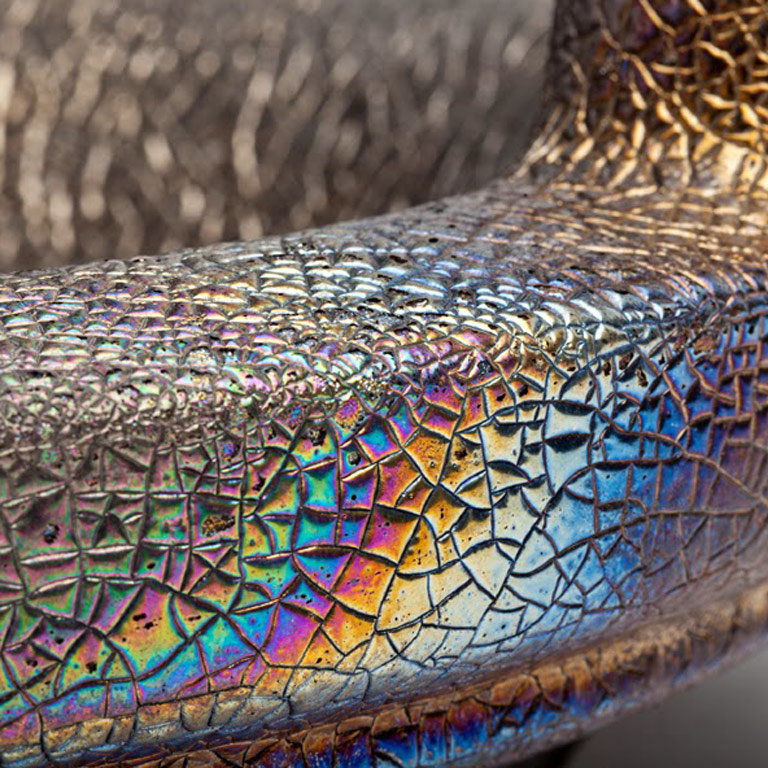 A detail image of a textured, multi-color ceramic vessel.