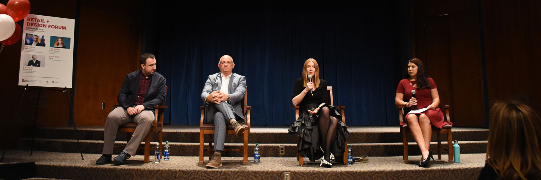 Four people participating in a panel discussion.