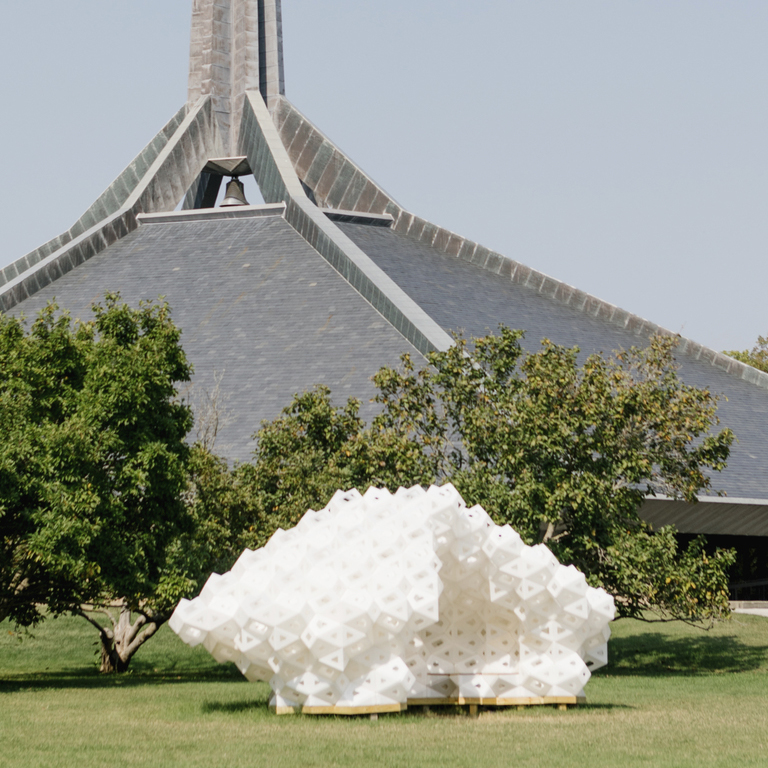 A large white sculpture made of plastic outdoors. 