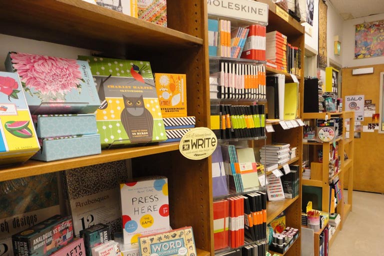 The interior of a bookstore with shelves full of items to purchase