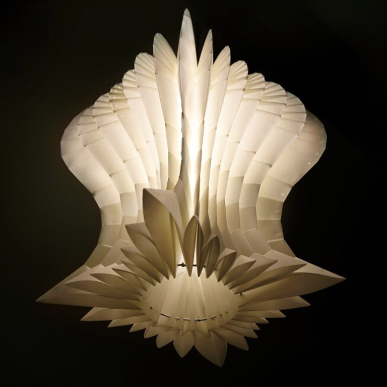 A paper lighting fixture against a black background
