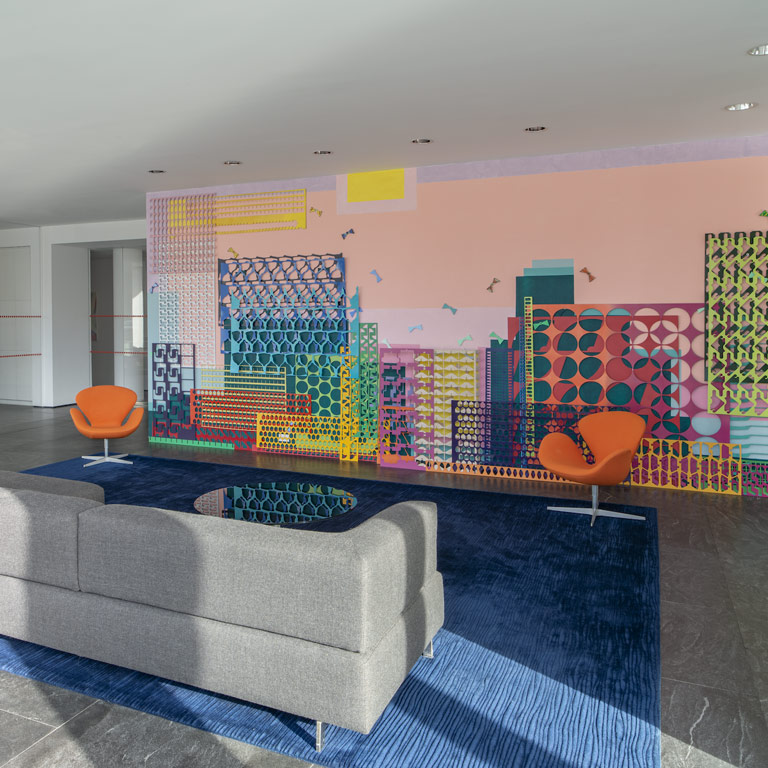A colorful architectural installation displayed in a room. 