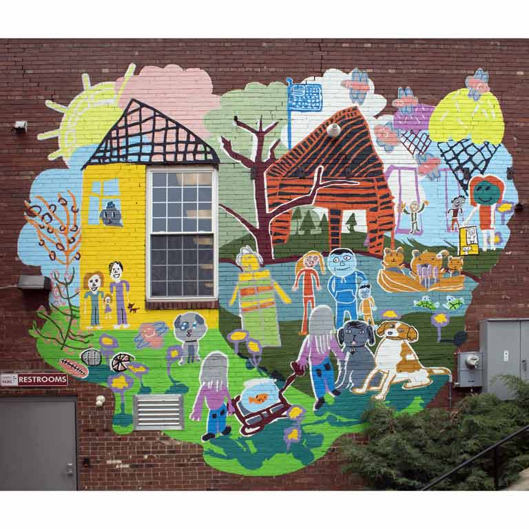 A colorful mural painted on the side of a brick building.