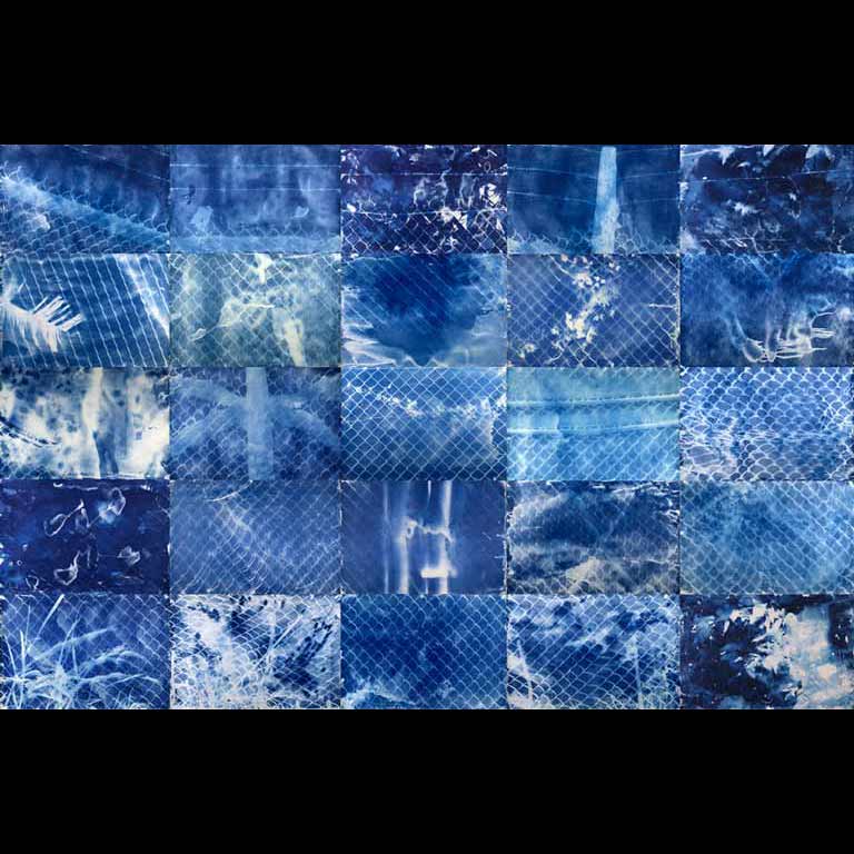 A series of blue and white photographs pieced together to create one artwork. 