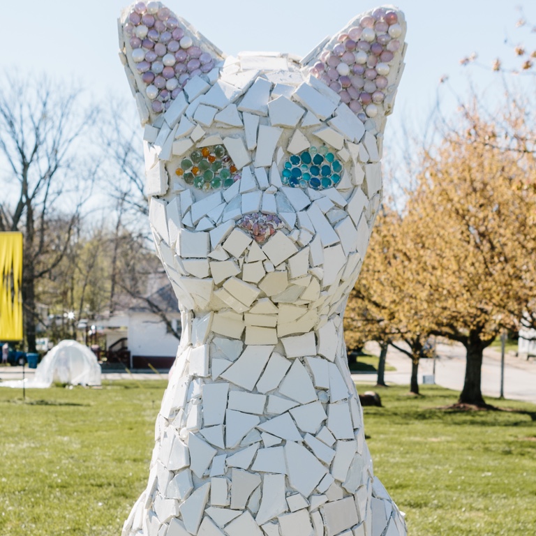 An outdoor sculpture of a cat.